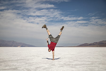 man with right hand on ground under blue sky thumbnail
