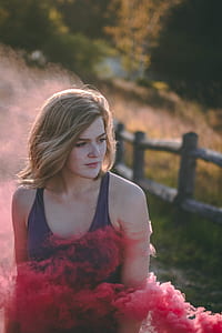 bokeh shot of woman surrounded by pink smoke thumbnail