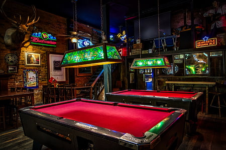 two red-and-brown pool tables inside the room beside brown wooden desk thumbnail