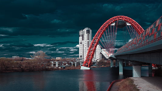 landscape photo of concrete bridge under river near high-rise buildings thumbnail