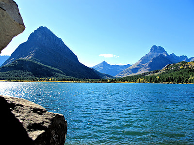 rock formations near body of water at daytime thumbnail