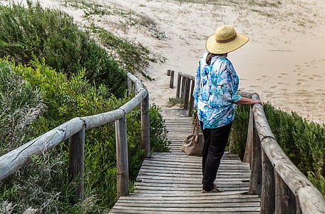 woman standing on brown wooden bridge thumbnail