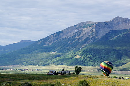photography of floating hot balloon at daytime thumbnail
