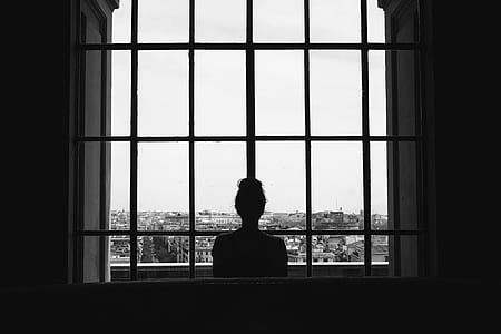 woman looking outside glass window thumbnail