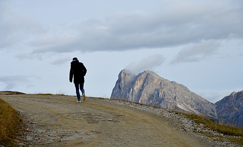 person walking on pathway during daytime thumbnail