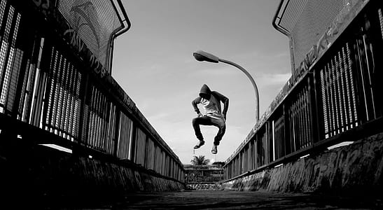 Man Jumping on Air Wearing Gray Hoodie thumbnail