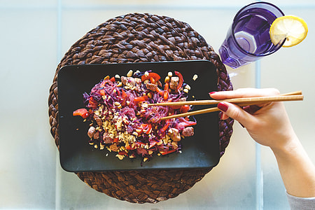Woman eating beet glass noodles thumbnail