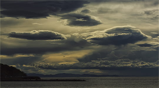 blue sea under blue cloudy sky thumbnail