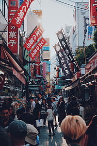 people on road near restaurants with kanji signs thumbnail