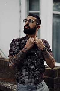 man wearing eyeglasses holding his button-up t-shirt thumbnail