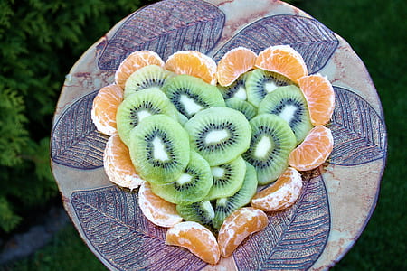 slice kiwis and lemons on brown ceramic plate thumbnail
