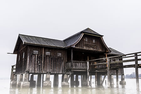 brown wooden house over body of water thumbnail