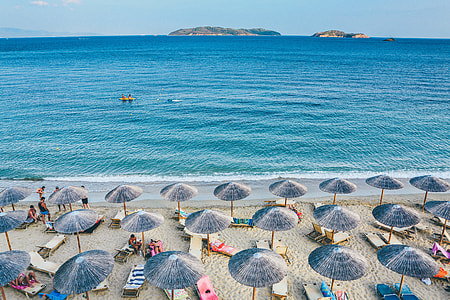 top view of blue beach umbrellas near seashore thumbnail