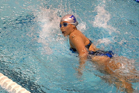 woman swimming on body of water thumbnail
