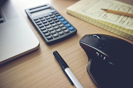 Home Office Setup Essentials Toolkit. Laptop, Wireless Mouse, Notepad and a Calculator. thumbnail