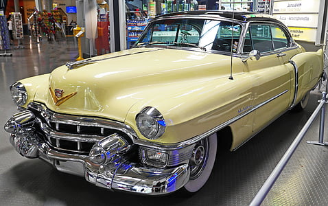 classic yellow Cadillac hardtop coupe indoors thumbnail