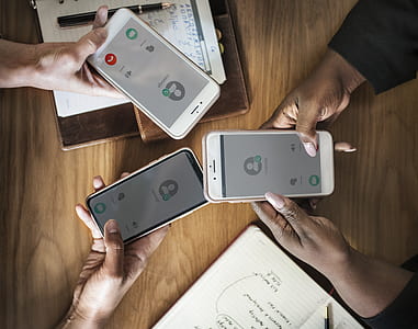three person holding iPhones taking calls thumbnail