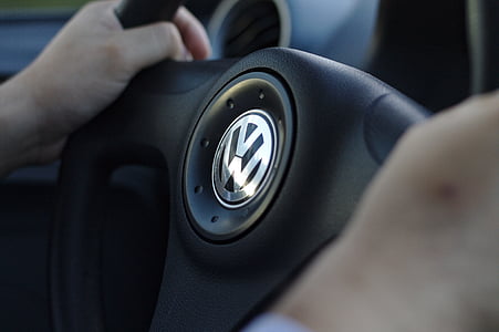 person holding black Volkswagen steering wheel thumbnail