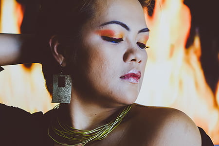 closeup photo of a woman behind fire thumbnail