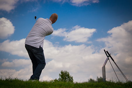worms eye view of man playing golf thumbnail