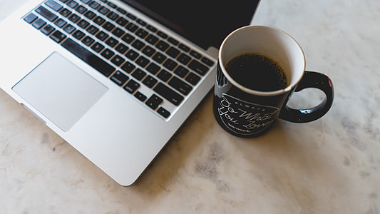 MacBook Pro and black ceramic mug thumbnail