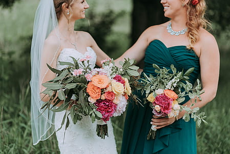bride near woman in green gown thumbnail