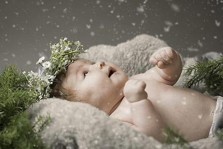 baby lying on gray textile thumbnail