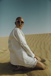 woman sitting on sand looking forward thumbnail