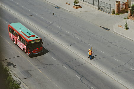 red and white bus on road thumbnail