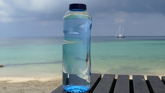 blue plastic water bottle near seashore thumbnail