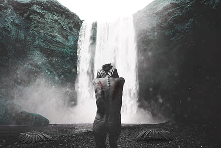 topless person infront of waterfalls thumbnail