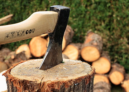 axe on log under sunny sky thumbnail