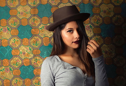 woman posing beside orange and teal wall thumbnail