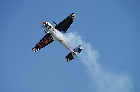 black and white monoplane under clear blue sky thumbnail