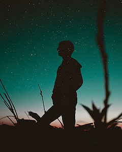 sillhouette of man staring at the sky during night thumbnail
