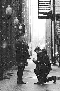 man kneeling in front of woman thumbnail