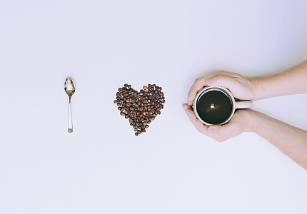 person holding ceramic mug thumbnail