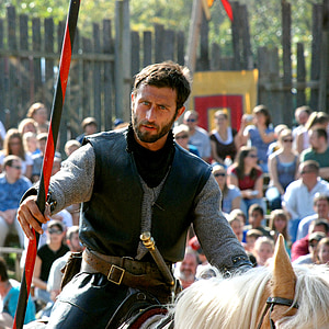 man ride on white horse surrounded people thumbnail