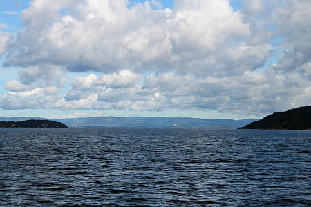 photo of beach under white and blue sky at daytime thumbnail