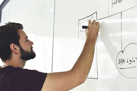 man holding black pen wearing black crew-neck short-sleeve shirt thumbnail