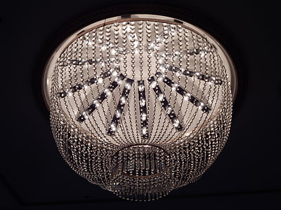 lighted white and gray chandelier inside dim lighted room thumbnail