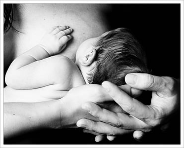 grayscale photo of mother carrying baby thumbnail