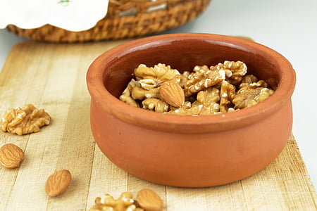 photo of brown almond brittles in brown clay pot thumbnail