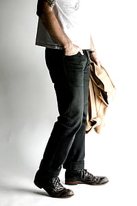 man carrying brown coat while standing inside well lighted room thumbnail