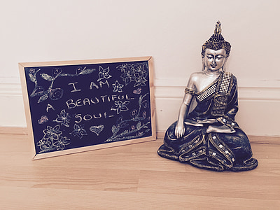 silver-colored Gautama Buddha figurine and black board thumbnail