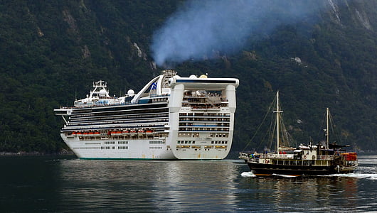 white cruiser ship near black boat thumbnail