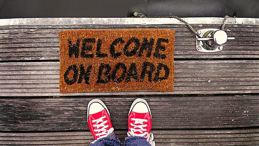 person standing beside welcome on board rug thumbnail