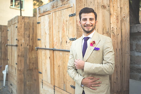 man standing beside wall thumbnail