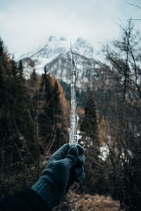 person holding ice near mountain alps thumbnail