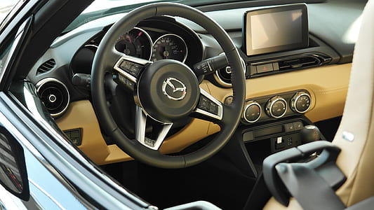 black and brown Mazda vehicle interior thumbnail